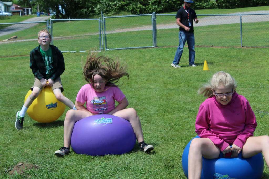 kids bouncing on giant balls